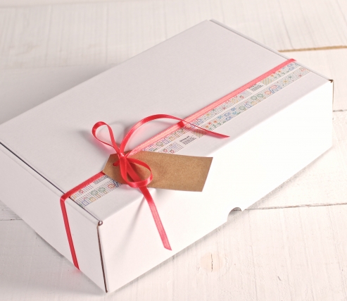Box decorated with washi tape and red ribbon